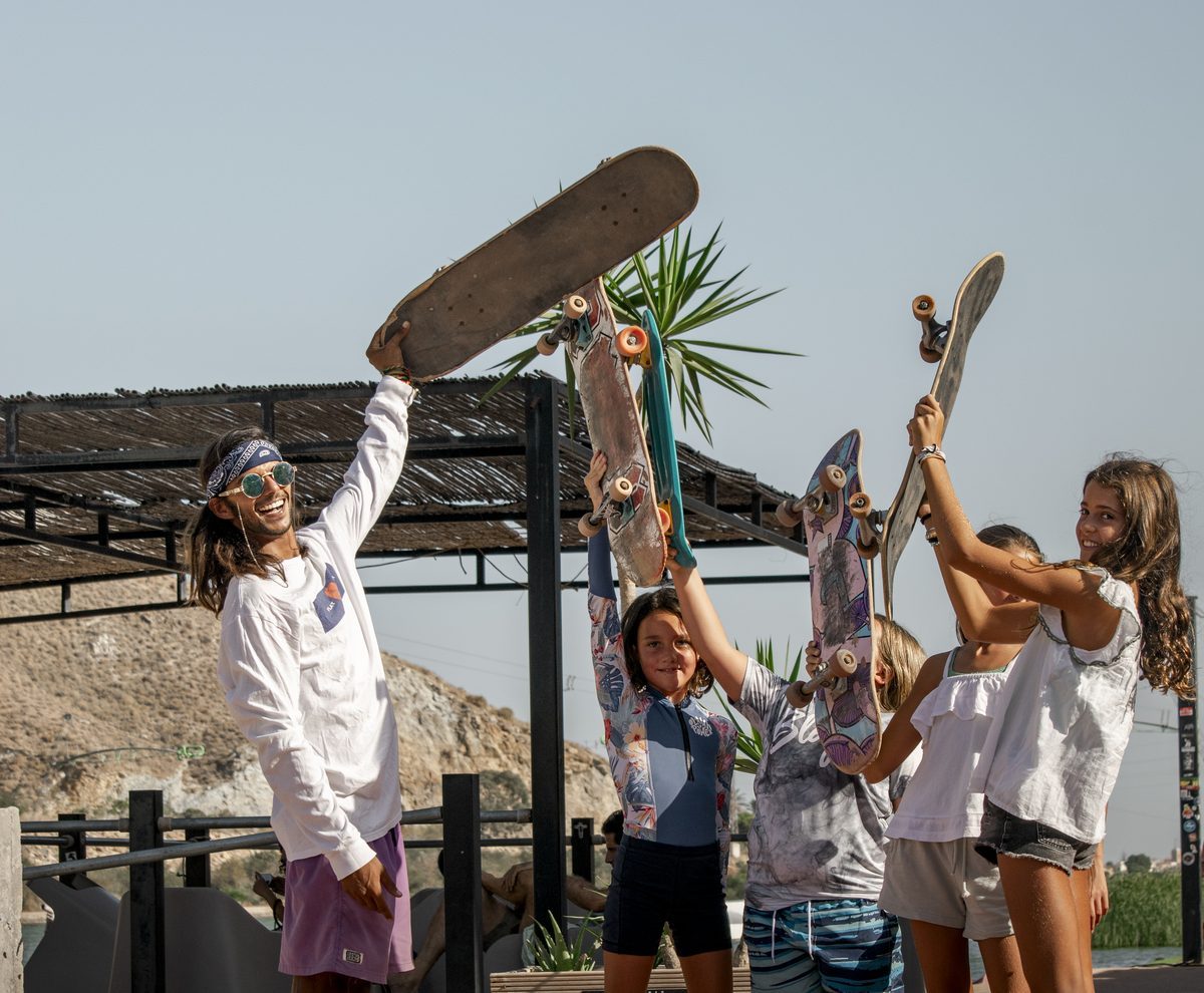 Kids raising skateboards at Lunar Cable Park